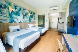 Rúm í herbergi á Solea Palm Resort Mactan