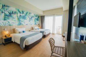 Rúm í herbergi á Solea Palm Resort Mactan