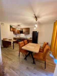 a kitchen with a table and two chairs and a table and a kitchen at New Apartment with balcony and free parking in Zadar