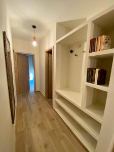 a hallway with bookshelves in a white room at New Apartment with balcony and free parking in Zadar