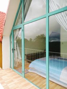 a window with a view of a swimming pool at Paradiso Homestay Mangden in Kon Von Kla