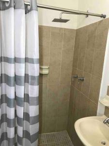 La salle de bains est pourvue d'un rideau de douche et d'un lavabo. dans l'établissement Cerca de Parque industrial Nava 3 hab (Facturable), à Ciudad Obregón