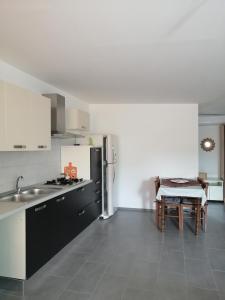 a kitchen with a sink and a refrigerator and a table at A casa di Bruna in Martella