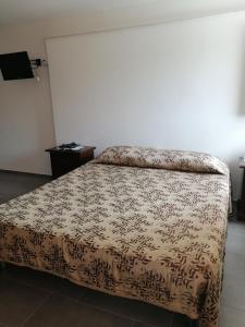 a bedroom with a bed with a blanket on it at A casa di Bruna in Martella