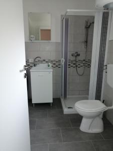 a bathroom with a toilet and a shower and a sink at A casa di Bruna in Martella