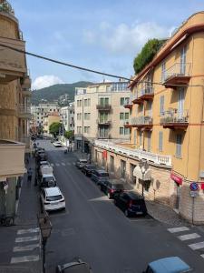 a city street with parked cars and buildings at VERDE Ridi Che Ti Passa in Alassio