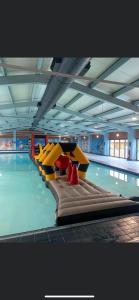 a swimming pool with a row of inflatable chairs at Gold Plus 6 Berth Caravan in NEW BEACH with parking WiFi and decking in Dymchurch