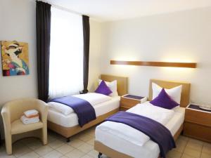 מיטה או מיטות בחדר ב-Hotel Rath