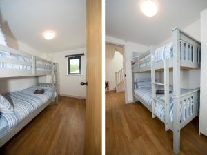 two bunk beds in a room with a hallway at Starling Lodge in Wedmore