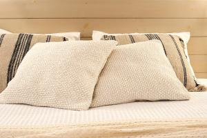 a group of pillows sitting on a bed at Paris Studios & Apartment in Agia Paraskevi