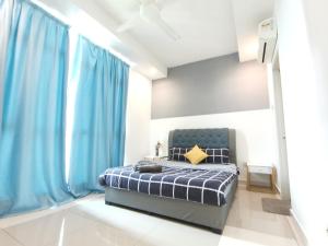 a bedroom with blue curtains and a bed with a yellow pillow at Exclusive Homestay at Central Residence, Kuala Lumpur in Kuala Lumpur +69 photos