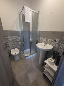 a bathroom with two sinks and a shower at Casa Giagoni in Santa Teresa Gallura