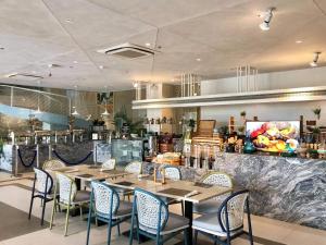 a restaurant with a table and chairs and a counter at Solea Palm Resort Mactan in Mactan