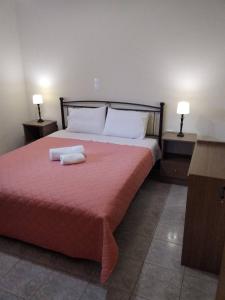 a bedroom with a bed with two towels on it at Manto House - Amalia Apartment in Káto Figália