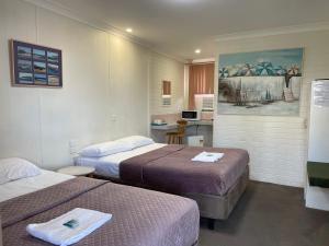 Postel nebo postele na pokoji v ubytování Bananatown Motel