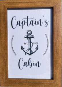 um sinal com uma âncora numa armação de madeira em Captain’s cabin em Koper