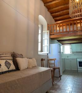 a living room with a couch and a kitchen at Ikia Wide Wild Summer House in Kollimpithra