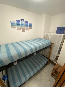 two bunk beds in a room with pictures on the wall at Appartamento Riflessi sul mare in Gaeta