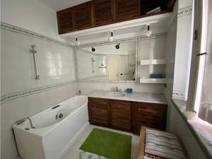 a bathroom with a tub and a sink and a mirror at da nico in Orbetello