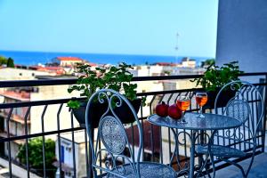 2 mesas con bebidas y manzanas en un balcón en Kore suites&apartments, en Locri