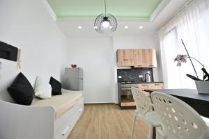 a living room with a couch and a table at Kore suites&apartments in Locri