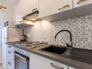 a kitchen with a sink and a stove at Merag Sunrise Apartment in Cres +4 photos