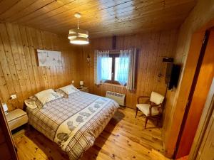 a bedroom with a bed in a wooden room at La Clusaz Ski aux pieds in La Clusaz