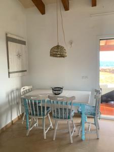a dining room with a table and chairs at Villa Calma in Cala en Bosc