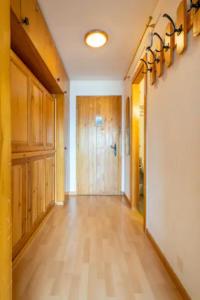 an empty hallway with wood paneling and a hallway with wooden cabinets at Center of Veysonnaz with a View ! in Veysonnaz