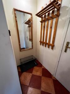 a hallway with a mirror and a tiled floor at Apartament Rodzinny in Rumia