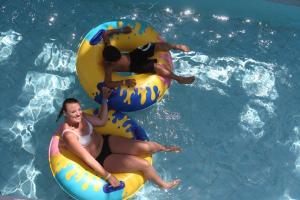 two people in the water on a raft in a pool at Anastasia Waterpark Beach Resort in Protaras