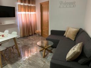 a living room with a couch and a table at -Apartamentos Laguna- in Puerto de Mazarrón