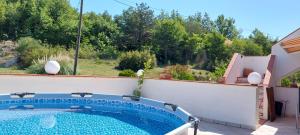 a swimming pool in the backyard of a house at ALIANA apartment in Sečovlje