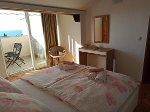 a bedroom with a large bed with towels on it at Villa Rea in Malinska
