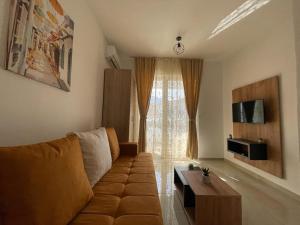 a living room with a couch and a table at Apartments Pericic in Sutomore
