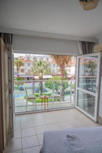 a bedroom with a bed and a balcony with a view at MUSE No 1 in Marmaris
