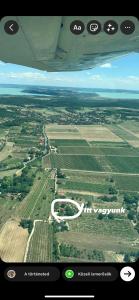 a view from the wing of an airplane flying over a field at Szőlőskert vendégház in Balatonszőlős