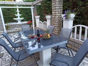 a table with a bowl of fruit on a patio at Villa Rea in Malinska