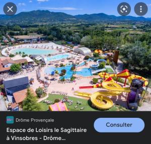 an image of a water park with a water slide at Les Lauriers centre ville avec jardin in Nyons