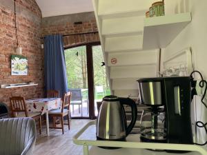 a kitchen with a coffee maker on a counter at Ostoja Miłolas in Lidzbark Warmiński