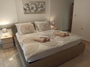a bedroom with a large bed with two pillows on it at Villa Rea in Malinska +87 photos