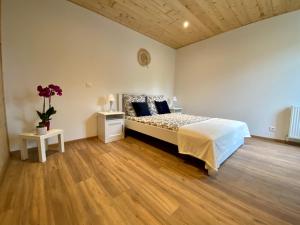 sypialnia z łóżkiem i drewnianą podłogą w obiekcie Gîte confort à Lamothe d Alès w mieście Lavergne