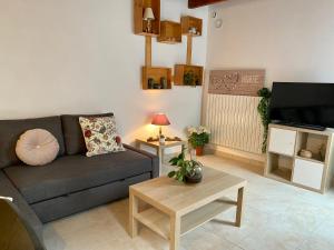 salon z kanapą i stołem w obiekcie Gîte confort à Lamothe d Alès w mieście Lavergne