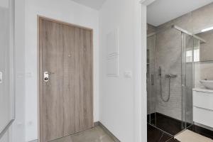 a bathroom with a shower and a wooden door at Apartment Angels Makarska in Makarska +17 photos