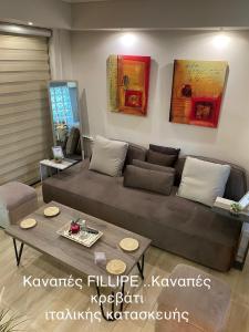 a living room with a couch and a table at Eva suite Vip excellent studio 1 in Athens