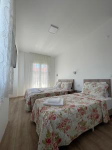 A bed or beds in a room at Adil Pansiyon