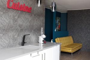 a kitchen with a sink and a yellow chair at Blue Point in Costa da Caparica