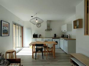 a kitchen with a table and chairs in a room at Appartement rénové 4 pers avec parking à Cauterets - FR-1-234-242 in Cauterets +6 photos