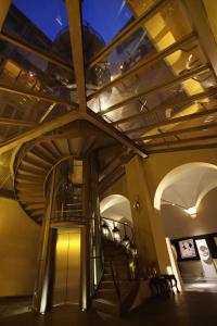 a spiral staircase in a building with a ceiling at Borghese Palace Art Hotel in Florence