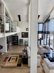 a living room with white furniture and a staircase at Villa Valentina in Ulcinj